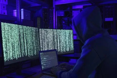 Hacker working with computers in dark room. Cyber attack 库存照片