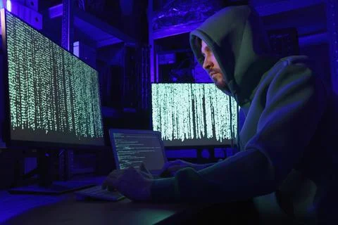 Hacker working with computers in dark room. Cyber attack Stock Photos
