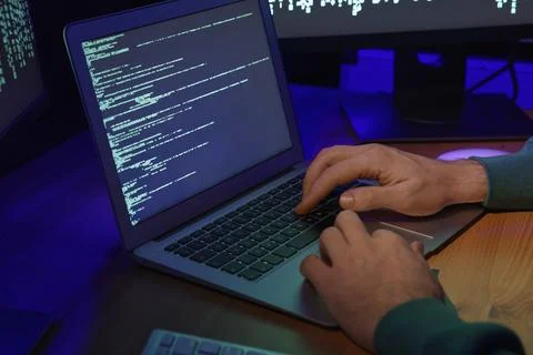 Hacker working with computers at wooden table, closeup. Cyber attack 库存照片
