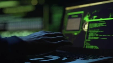 Hacker working on creating malicious software, actively typing on laptop keypad Stock Footage 84116098