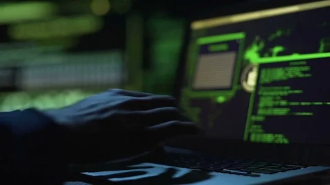 Hacker working on creating malicious software, actively typing on laptop keypad Video stock 84117535