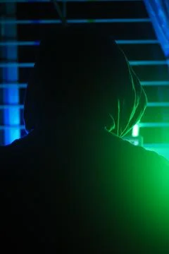 A hacker working in a dark room, cyber crime concept Stock Photos