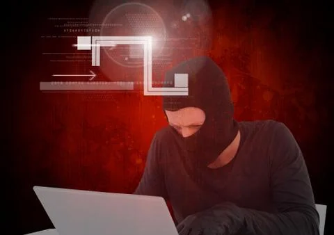 Hacker working on laptop in front of digital red background 写真素材