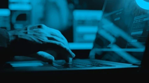 Hacker is working on laptop at night. Hands are typing a virus code at keyboard Stock Footage 126162652