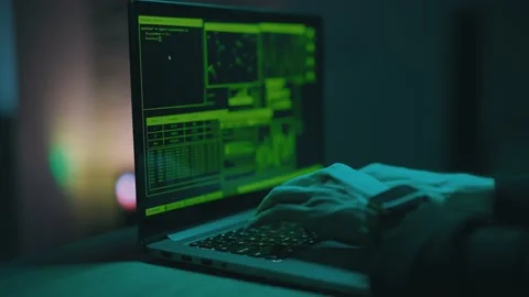 Hacker is working on laptop at night. Hands are typing a virus code at keyboard Stock Footage 150428095