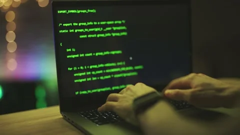 Hacker is working on laptop at night. Hands are typing a virus code at keyboard Stock Footage 150864734