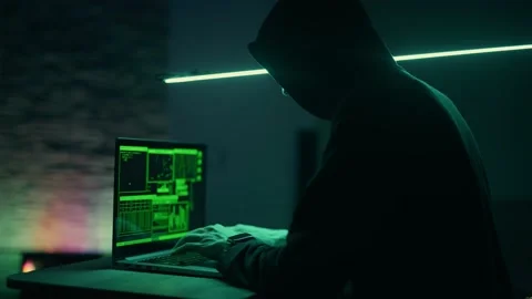 Hacker is working on laptop at night. Hands are typing a virus code at keyboard Stock Footage 154705628
