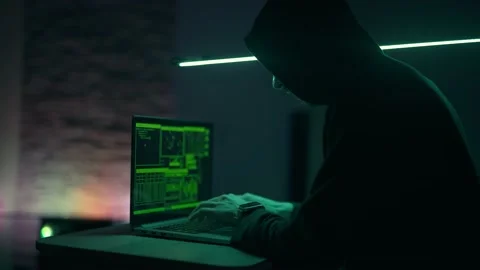Hacker is working on laptop at night. Hands are typing a virus code at keyboard Stock Footage 157023198