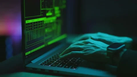 Hacker is working on laptop at night. Hands are typing a virus code at keyboard Stock Footage 157023499