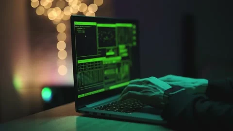 Hacker is working on laptop at night. Hands are typing a virus code at keyboard Stock Footage 160087369