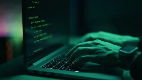 Hacker is working on laptop at night. Hands are typing a virus code at keyboard Stock Footage 161102862