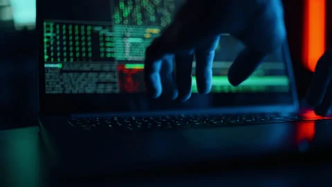 Hacker is working on laptop at night. Hands are typing a virus code at keyboard Video stock 163304788