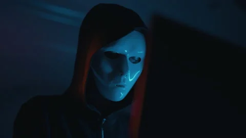 Hacker is working on laptop at night. Hands are typing a virus code at keyboard Stock Footage 164054733