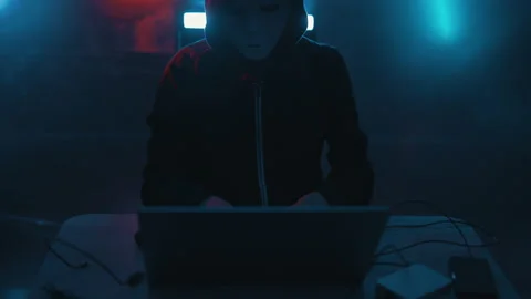 Hacker is working on laptop at night. Hands are typing a virus code at keyboard Stock Footage 164056854