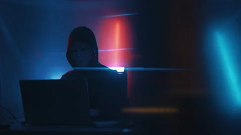 Hacker is working on laptop at night. Hands are typing a virus code at keyboard Stock Footage 164057793