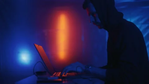 Hacker is working on laptop at night. Hands are typing a virus code at keyboard Stock Footage 164058957