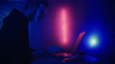 Hacker is working on laptop at night. Hands are typing a virus code at keyboard Stock Footage 164059849