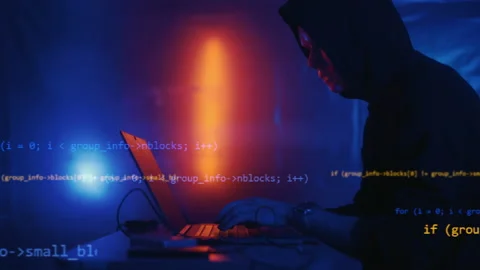 Hacker is working on laptop at night. Hands are typing a virus code at keyboard Stock Footage 164559399