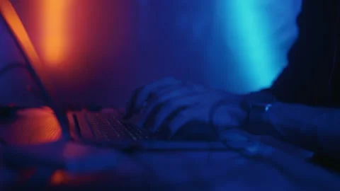 Hacker is working on laptop at night. Hands are typing a virus code at keyboard Stock Footage 165212898