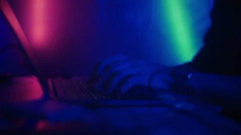 Hacker is working on laptop at night. Hands are typing a virus code at keyboard Stock Footage 166896478