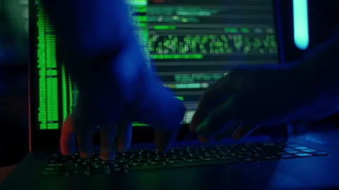 Hacker is working on laptop at night. Hands are typing a virus code at keyboard Stock Footage 166897692