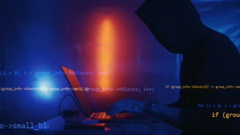 Hacker is working on laptop at night. Hands are typing a virus code at keyboard Stock Footage 167940705