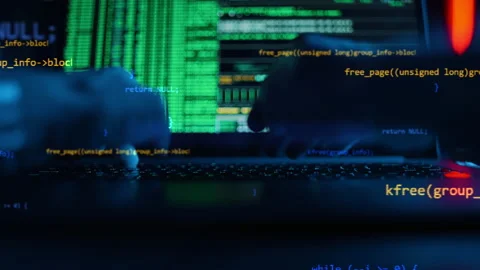 Hacker is working on laptop at night. Hands are typing a virus code at keyboard Stock Footage 168856777