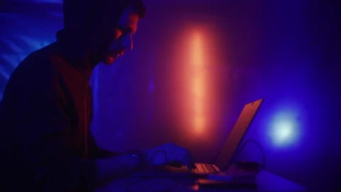 Hacker is working on laptop at night. Hands are typing a virus code at keyboard Stock Footage 170571392