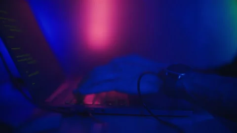 Hacker is working on laptop at night. Hands are typing a virus code at keyboard Stock Footage 195983184
