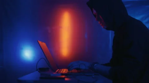 Hacker is working on laptop at night. Hands are typing a virus code at keyboard Stock Footage 195984239
