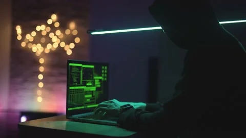 Hacker is working on laptop at night. Hands are typing a virus code at keyboard Stock Footage 197077683