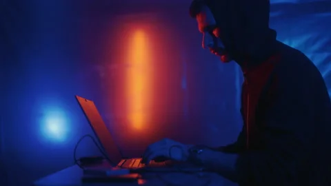 Hacker is working on laptop at night. Hands are typing a virus code at keyboard Stock Footage 201346706