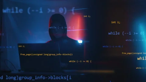 Hacker is working on laptop at night. Hands are typing a virus code at keyboard Stock Footage 201346823