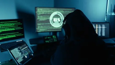 Hacker working on laptop at night in modern workspace. Hacker or cyber criminal. 写真素材