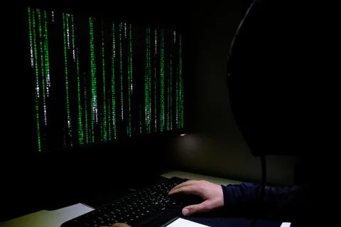 Hacker working on pc privacy data decript, cyber web securit,matrix code running Foto stock