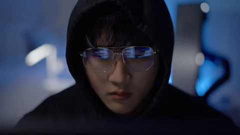 Hacker working on penetration testing and cybersecurity exploits to analyze Stock Footage 313824987