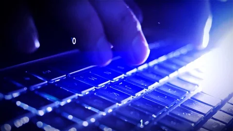 Hacker writing binary data code on laptop at night in close up Stock Footage 124704201