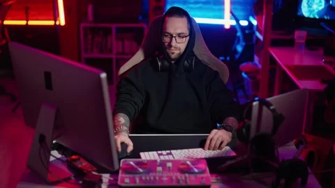 Hacker writing code cracking computer. Man programmer in hoodie cracks system Stock Footage 272792513