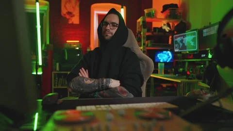 Hacker writing code cracking computer. Man programmer in hoodie cracks system Stock Footage 272909141
