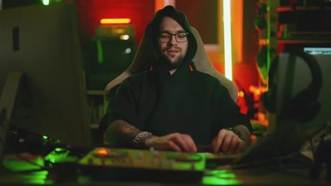 Hacker writing code cracking computer. Man programmer in hoodie cracks system Stock Footage 272909174