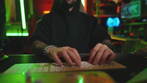 Hacker writing code cracking computer. Man programmer in hoodie cracks system Stock Footage 272909205