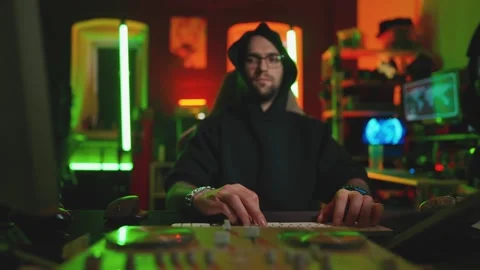 Hacker writing code cracking computer. Man programmer in hoodie cracks system Stock Footage 272909787