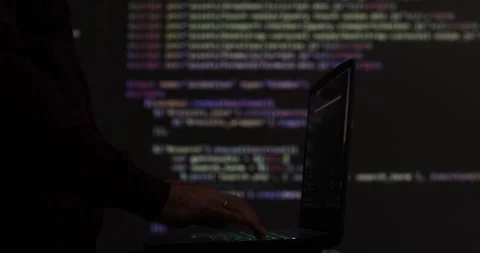 Hacker writing code cracking computer. Programming code in the background Stock Footage 278529357
