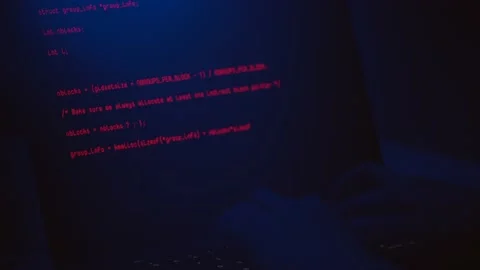 Hacker writing codes in red color to make an illegal cyber attack Stock Footage 155941494