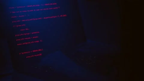 Hacker writing codes in red color to make an illegal cyber attack Stock Footage 155941547