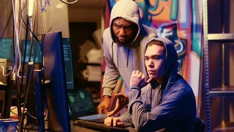 Hackers brainstorm ways of hacking PCs Stock Photos