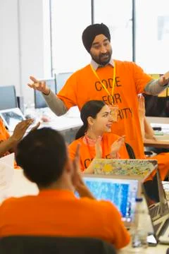 Hackers clapping, coding for charity at hackathon 스톡 사진