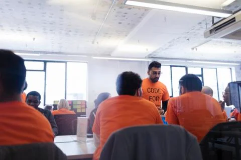 Hackers coding for charity at hackathon 스톡 사진