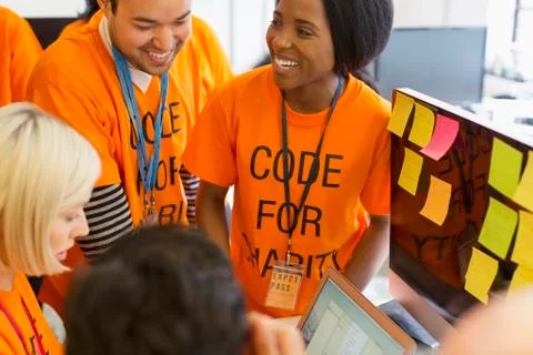 Hackers coding for charity at hackathon 스톡 사진