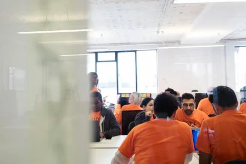 Hackers coding for charity at hackathon Stock Photos